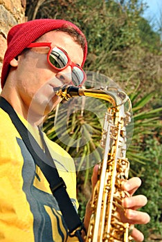 Modern musician posing with his saxophone