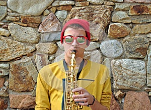 Modern musician posing with his saxophone