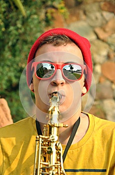 Modern musician posing with his saxophone