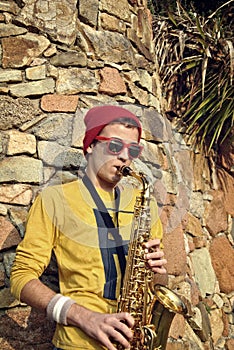 Modern musician posing with his saxophone