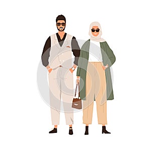 Modern Muslim couple of Arab man and woman. Portrait of Arabian female in hijab and pants and male in fashion suit