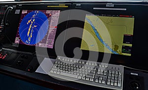Modern navigation control panel showing radar and gps data on ship bridge