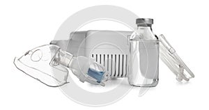 Modern nebulizer with face mask and liquid medicine on white background. Inhalation equipment