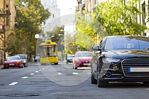 Modern new car on the side of the street. Rows of cars parked on