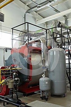 Modern new gas heating coppers work in a boiler room.