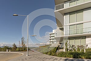 Modern, new high-rise residential building, a table and wicker c