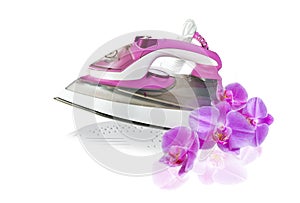 Modern new pink electric iron and orchid flowers