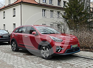 Modern new red electric suv car Kia Niro EV front and right side