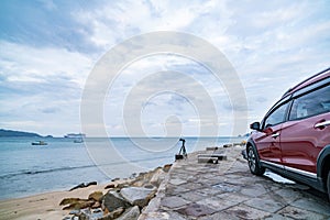 Modern new red SUV car on the road with Summer sea background of free space for summer text and travel transportation background