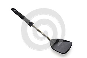 Modern non stick spade of frying pan or spatula in black color and stainless steel on white isolated background with clipping path