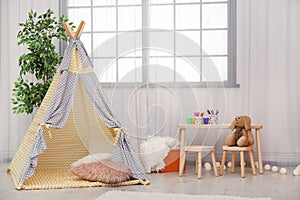 Modern nursery room interior with play tent