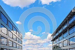 Modern office building against blue cloudy sky