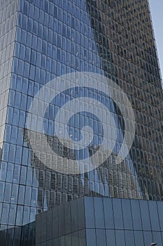 Modern office building with blue glass windows. The concept of a high-rise building.