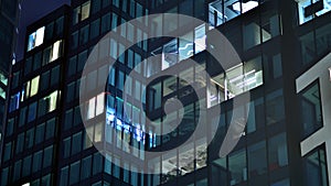 Modern office building in city at the night. View on illuminated offices of a corporate building.