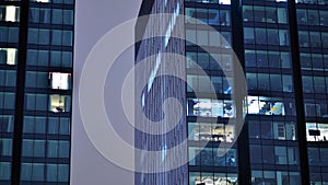 Modern office building in city at the night. View on illuminated offices of a corporate building.