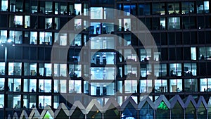 Modern office building in city at the night. View on illuminated offices of a corporate building.