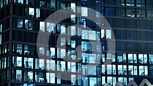 Modern office building in city at the night. View on illuminated offices of a corporate building.