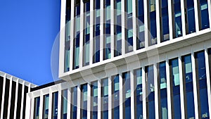 Modern office building in the city with windows and steel and aluminum panels wall.