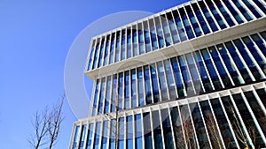 Modern office building in the city with windows and steel and aluminum panels wall.