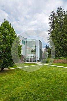 Modern office building with concrete pathways in front and trees around