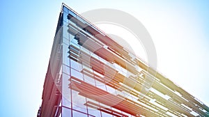 Modern office building detail, glass surface with sunlight