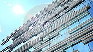 Modern office building detail, glass surface with sunlight