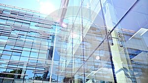 Modern office building detail, glass surface with sunlight