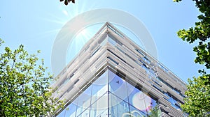 Modern office building detail, glass surface with sunlight