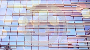 Modern office building detail, glass surface with sunlight