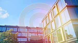 Modern office building detail, glass surface with sunlight