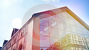 Modern office building detail, glass surface with sunlight