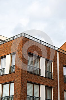 Modern office building exterior with glass facade on clear sky background. Transparent glass wall of office building