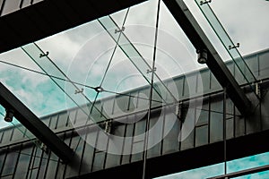 Modern office building exterior with glass facade on clear sky background. Transparent glass wall of office building