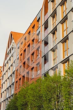 Modern office building exterior with glass facade on clear sky background. Transparent glass wall of office building