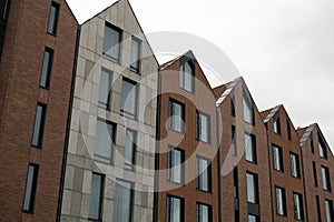 Modern office building exterior with glass facade on clear sky background. Transparent glass wall of office building