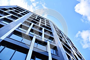 Modern office building facade abstract fragment, shiny windows in steel structure