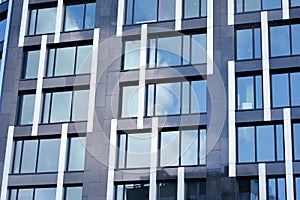 Modern office building facade abstract fragment, shiny windows in steel structure