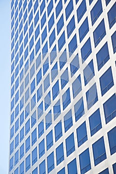 Modern office building reflecting blue sky