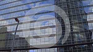 Modern office building reflecting Vienna International Centre and sky, Austria