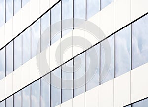 A modern office building rows of windows abstract background macro / closeup. Glass and metal architecture concept