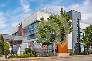 Modern office building in a sunny summer day with blue sky. Front view of the Cultural Center building in Surrey BC