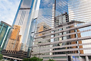 Modern office buildings in central Hong Kong. Modern architecture with windows reflecting sky and clouds.