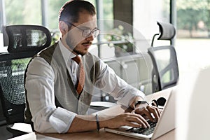 Modern Office Businessman Working on Computer. Portrait of Successful Middle-aged IT Software Engineer Working on Laptop