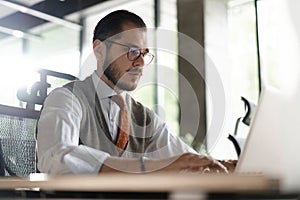 Modern Office Businessman Working on Computer. Portrait of Successful Middle-aged IT Software Engineer Working on Laptop