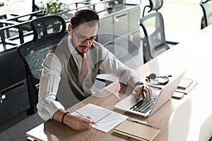 Modern Office Businessman Working on Computer. Portrait of Successful Middle-aged IT Software Engineer Working on Laptop