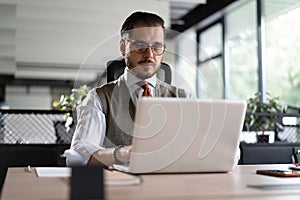 Modern Office Businessman Working on Computer. Portrait of Successful Middle-aged IT Software Engineer Working on Laptop