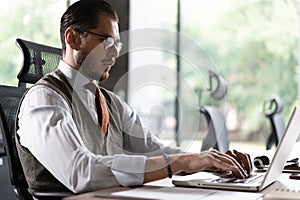 Modern Office Businessman Working on Computer. Portrait of Successful Middle-aged IT Software Engineer Working on Laptop