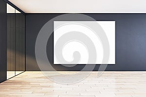 Modern office corridor interior with blank white poster on a dark wall, wooden flooring, and glass partition, concept of branding