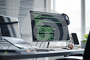 Modern Office Desk Featuring Computer Monitor Displaying Programming Code