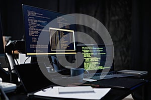 Modern Office Desk Featuring Computer Monitors Displaying Programming Code